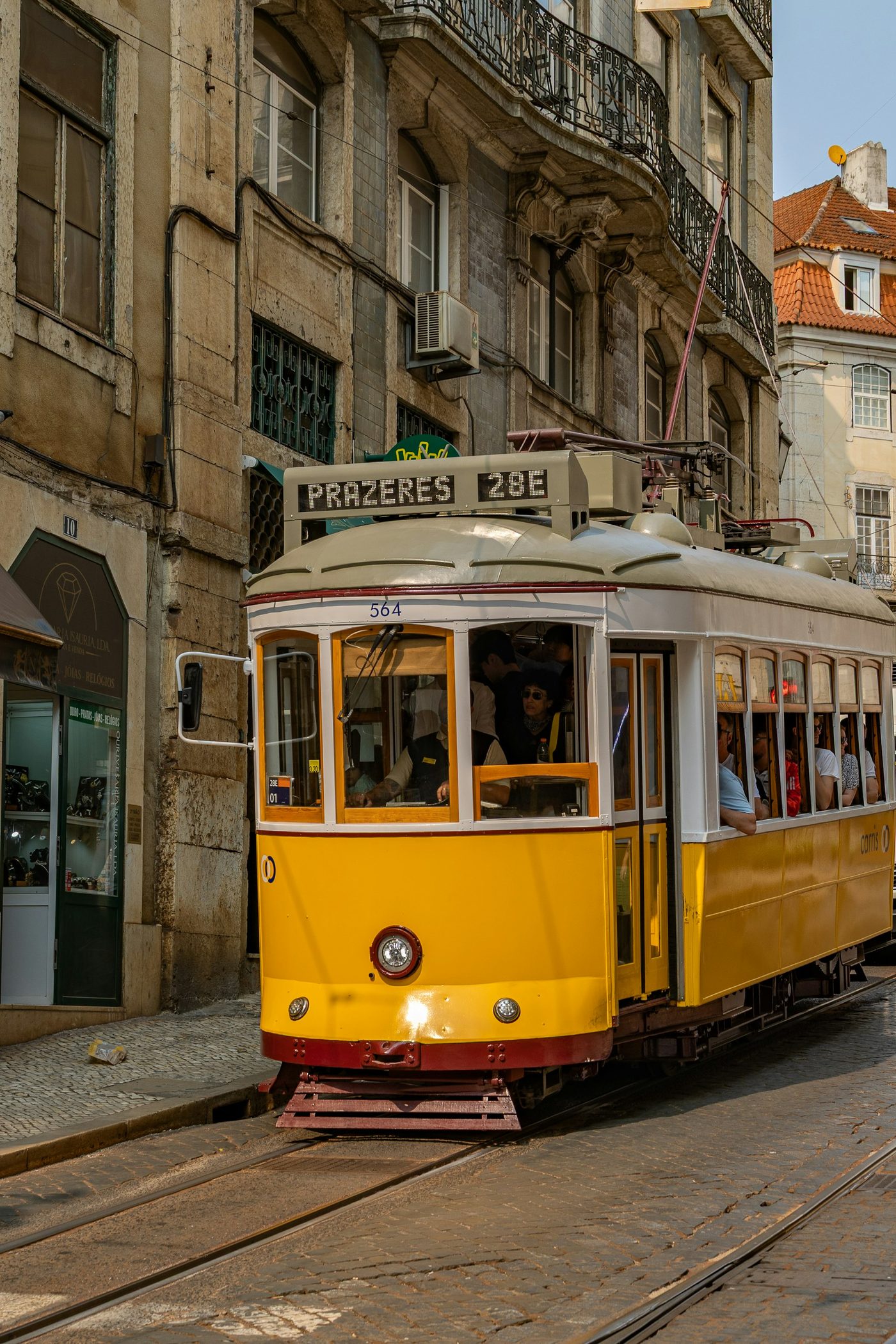 A yellow tram on the streets of Lisbon, where the road trip begins